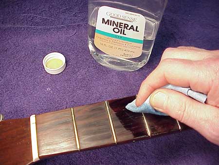 Cleaning guitar fretboard with Lemon Oil Compound. 